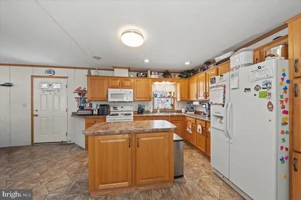 a kitchen with refrigerator a stove and cabinets