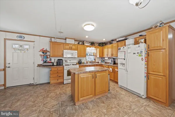 a kitchen with refrigerator and cabinets