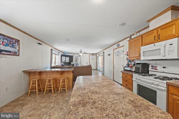 a kitchen with stainless steel appliances kitchen island granite countertop a sink and cabinets