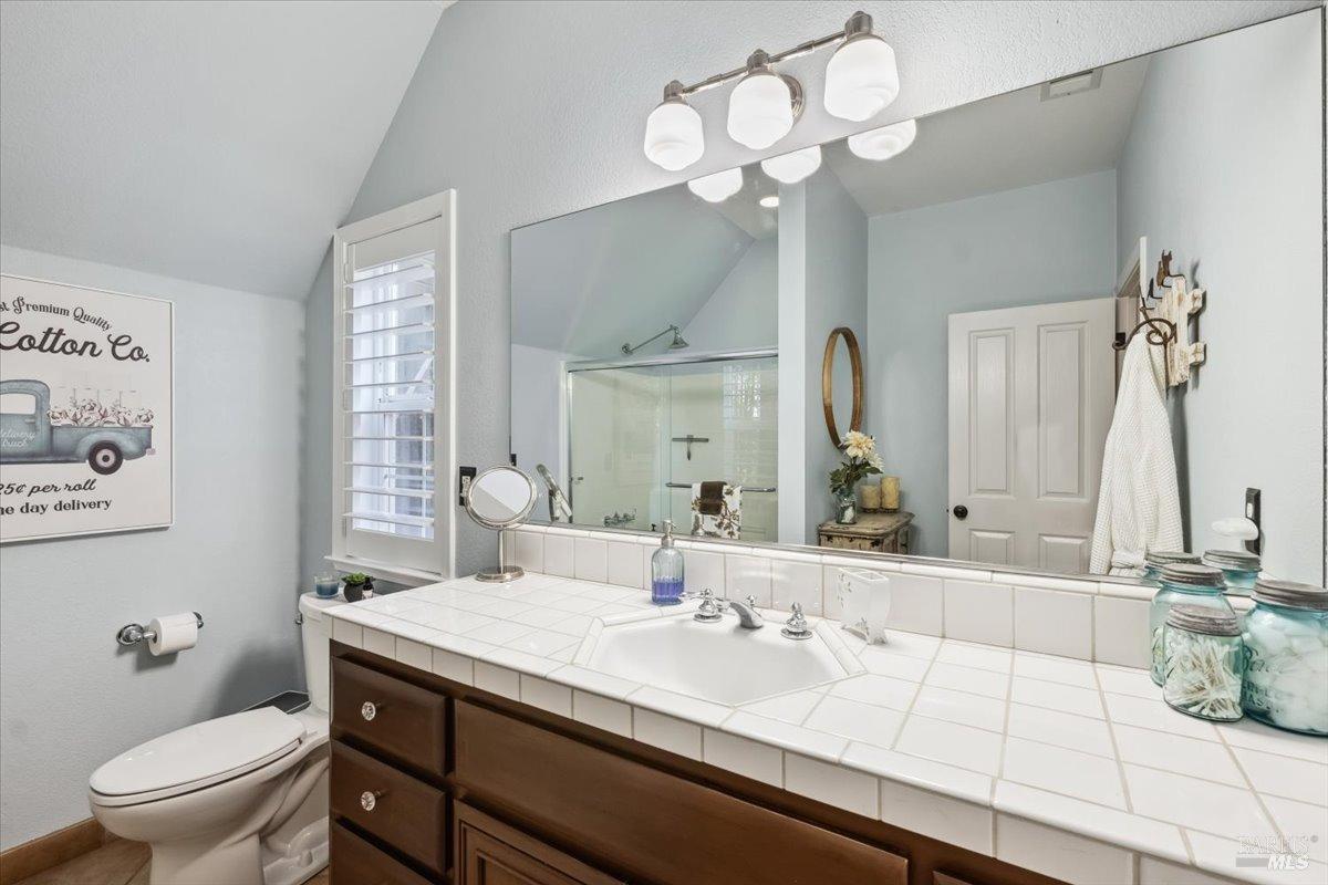 5701 Ridgewood Road Willits, CA 95490 - Photo 44 of 84 a bathroom with a granite countertop sink a toilet and a mirror