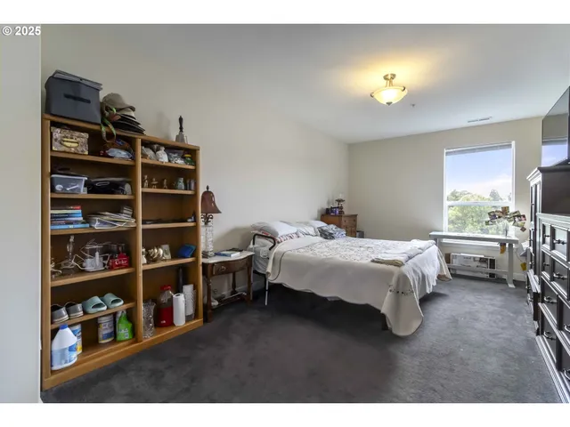 a bedroom with a bed furniture and decor