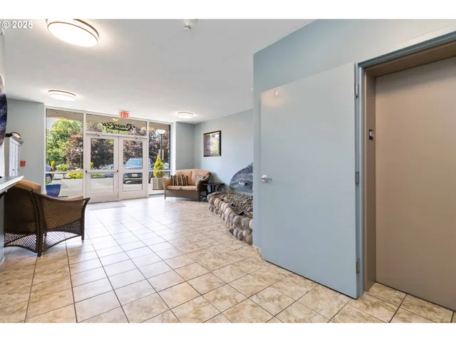 a living room with furniture a dining table and a potted plant