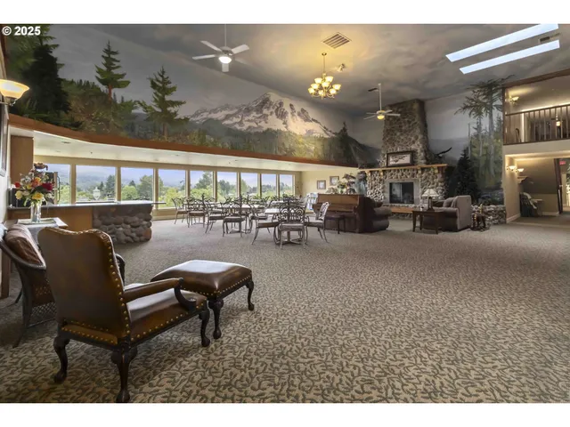 a living room with furniture a floor to ceiling window and outdoor view