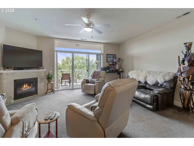 a living room with furniture a fireplace and a flat screen tv