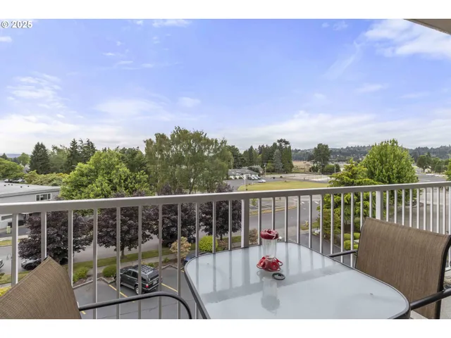 a view of roof deck with two chairs and wooden floor