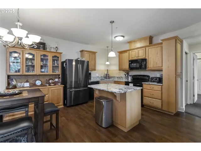 a kitchen with a refrigerator a microwave a stove and cabinets