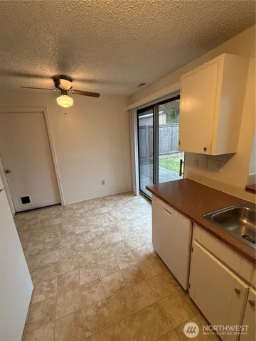 a view of an empty room with a fireplace and a window