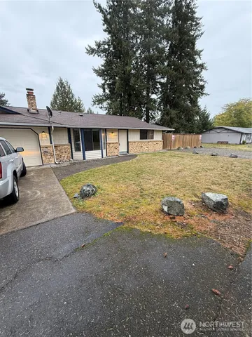 a view of a house with pool and a yard