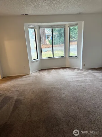 a view of empty room with a fireplace