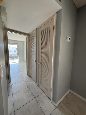a bathroom with a granite countertop toilet and a sink