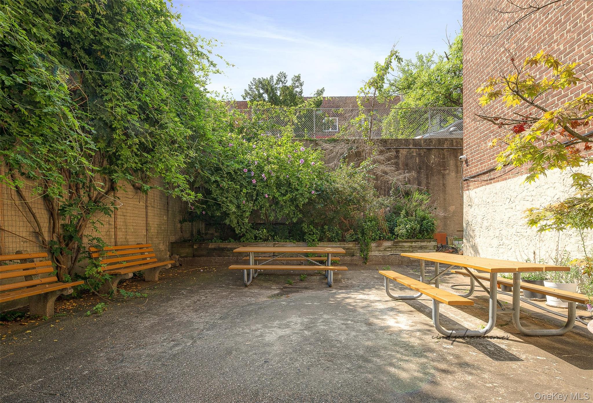 67-30 Clyde Street, Unit 6W Queens, NY 11375 - Photo 31 of 32 a view of a bench in a backyard