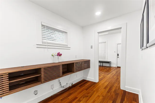 a room with a table chairs and a kitchen