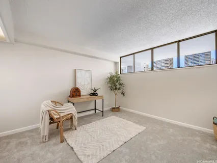 a living room with furniture and flowers