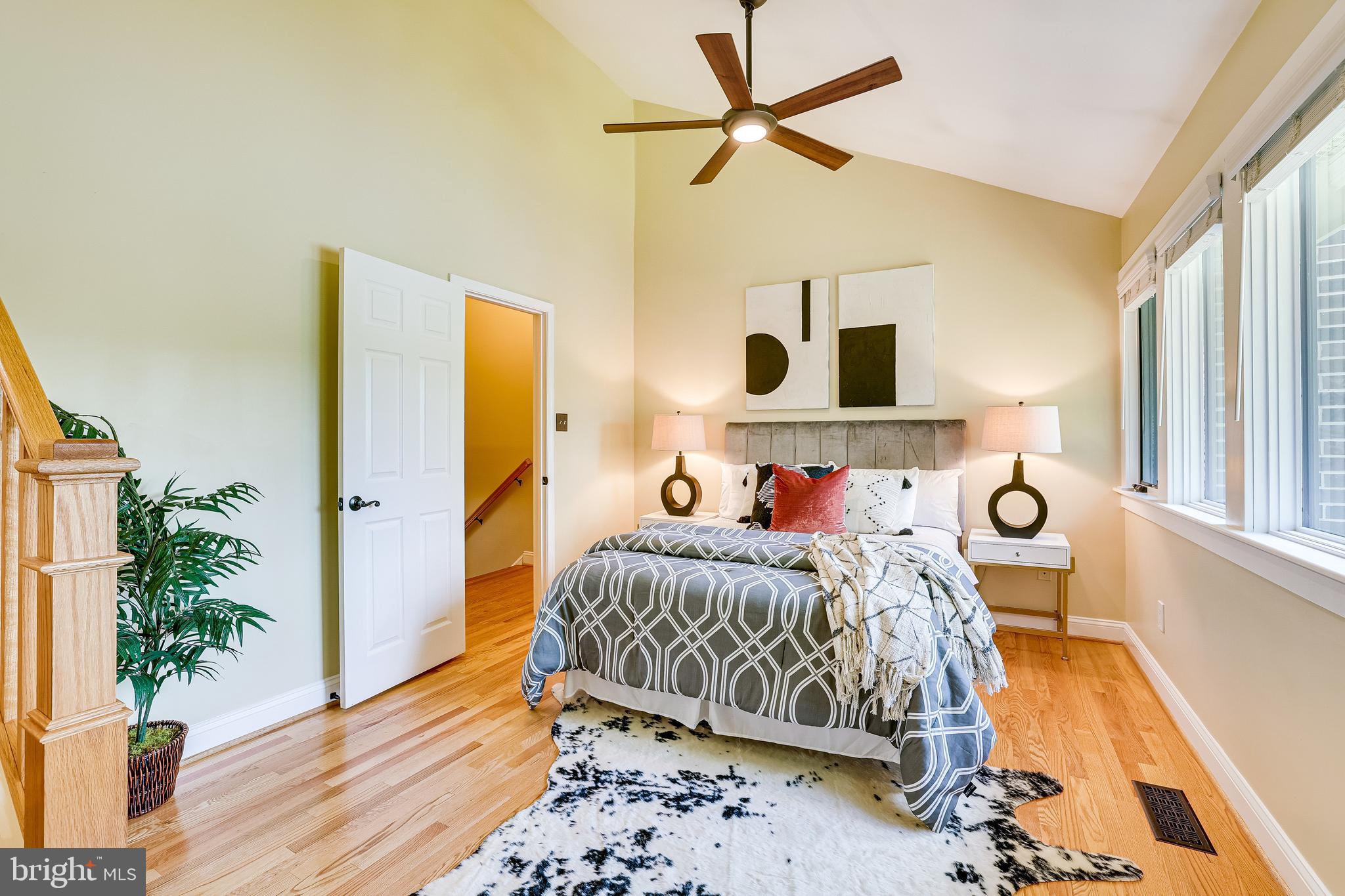 11056 Thrush Ridge Road Reston, VA 20191 - Photo 27 of 62 a bedroom with a bed and wooden floor