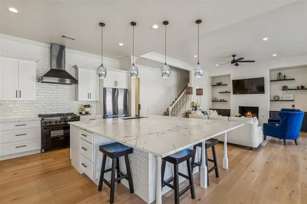 a large kitchen with stainless steel appliances kitchen island a large island in the center