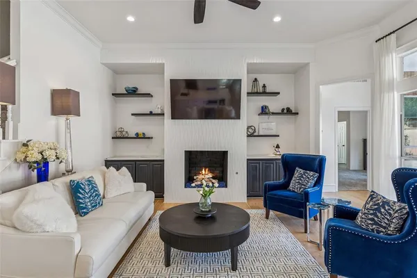 a living room with furniture a rug and a fireplace
