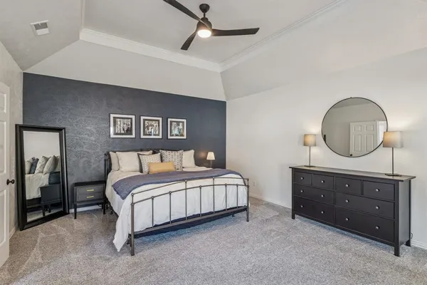 a bedroom with a bed and a dresser