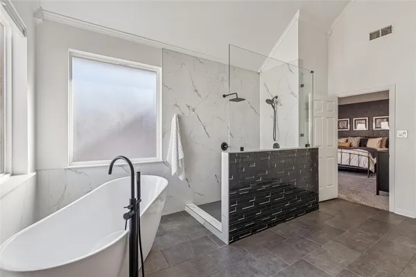 a bathroom with a bathtub and a shower