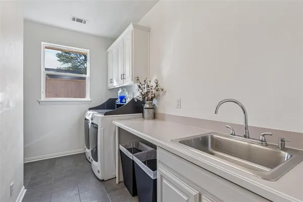 a kitchen with a sink and cabinets