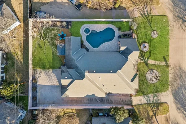 an aerial view of a house with a swimming pool