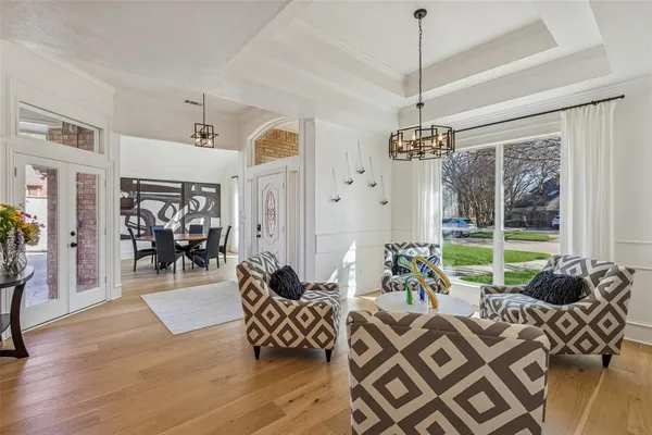 a living room filled with furniture and a chandelier