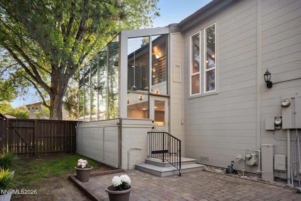a view of a backyard with a large tree