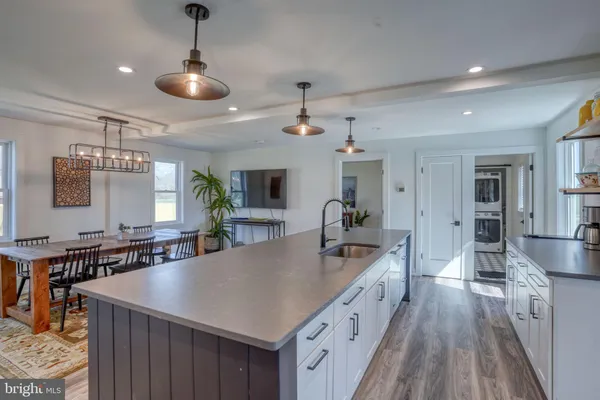 a large kitchen with lots of counter space and wooden floor