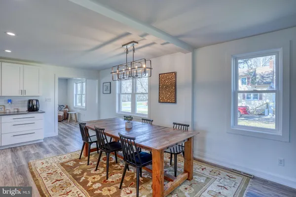 a kitchen with stainless steel appliances granite countertop a sink a stove and wooden cabinets