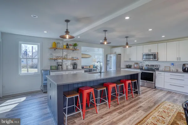 a kitchen with refrigerator cabinets and wooden floor