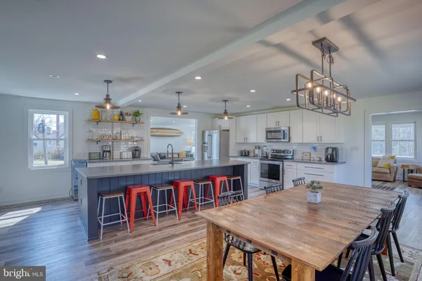 a living room with furniture stairs and a wooden floor
