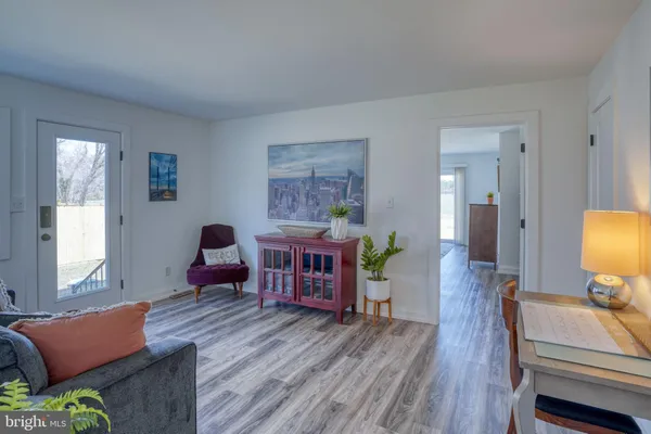 a bedroom with a bed and dresser with mirror