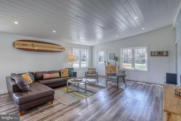 a kitchen with furniture wooden floor and a potted plant