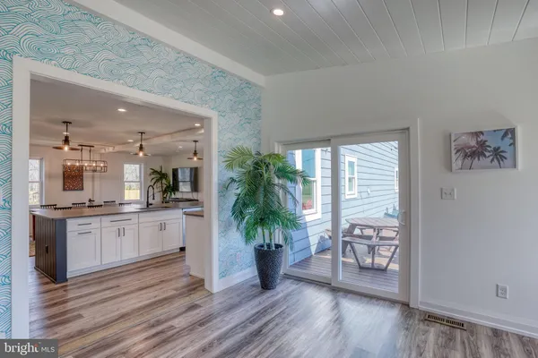 a kitchen with stainless steel appliances granite countertop a sink stove and wooden floor