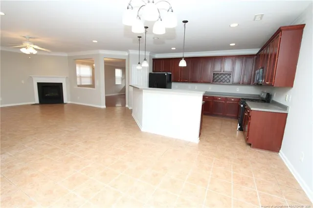 a large kitchen with kitchen island a sink a stove and a refrigerator