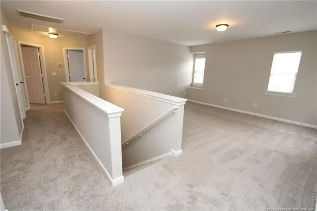 a view of hallway with bathroom