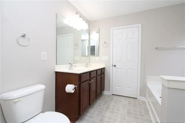 a bathroom with a sink vanity mirror and toilet