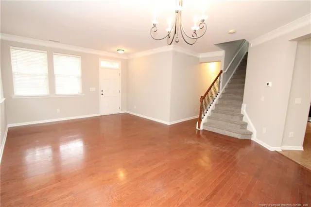a view of a room with wooden floor and white walls