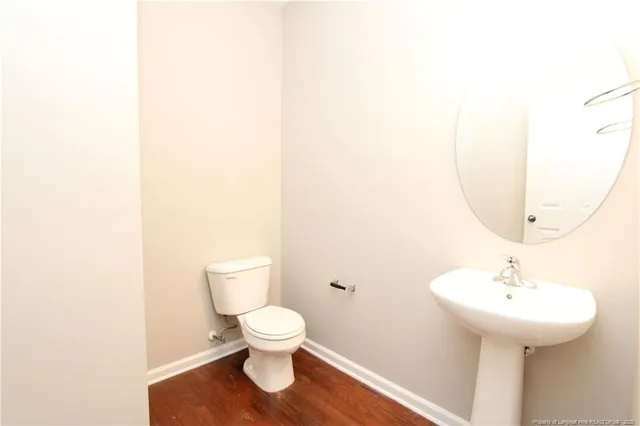 a bathroom with a sink toilet and a mirror