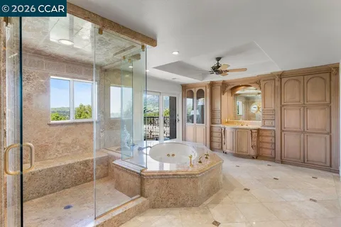 a bathroom with a tub a sink and shower