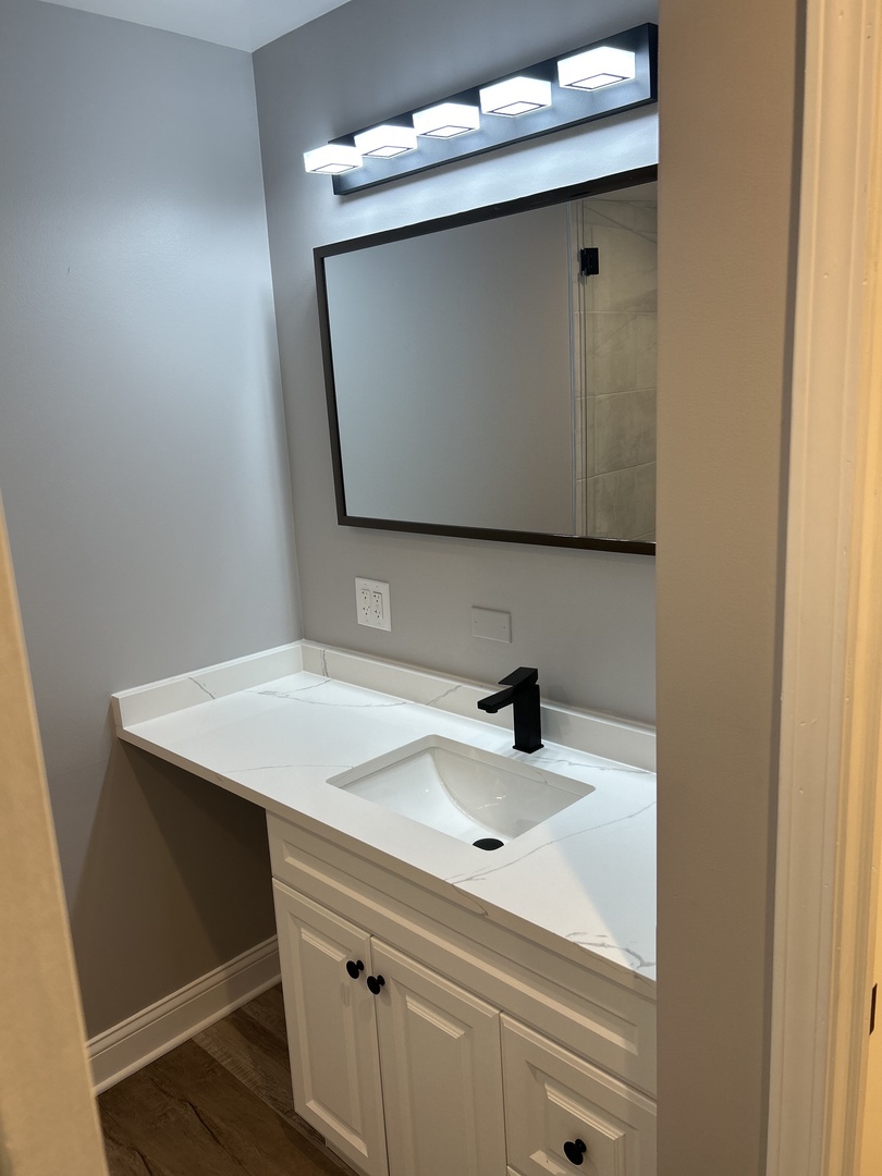 Undisclosed Address Naperville, IL 60563 - Photo 23 of 43 a bathroom with a sink and a mirror