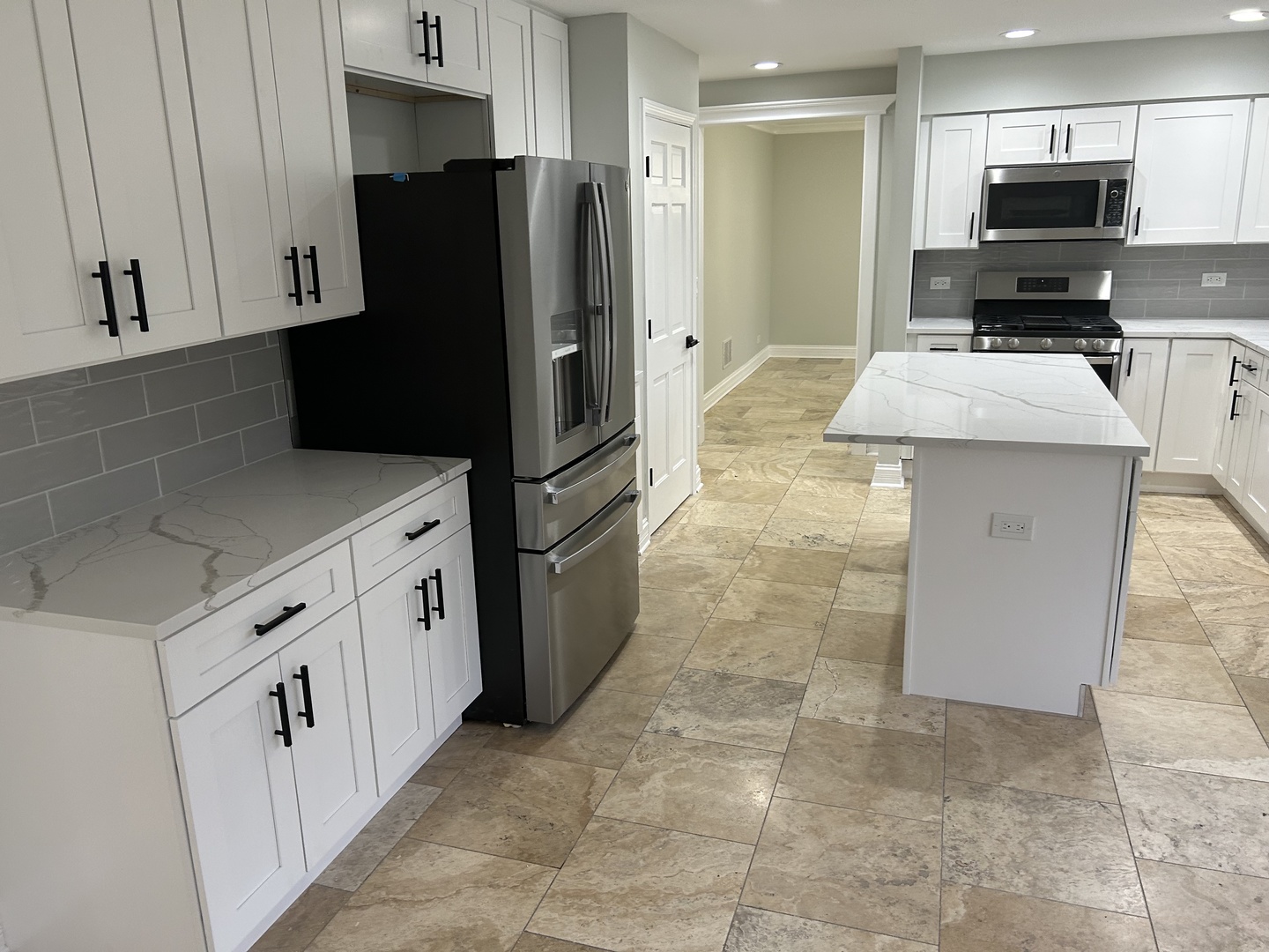 Undisclosed Address Naperville, IL 60563 - Photo 10 of 43 a kitchen with granite countertop a refrigerator a stove a microwave and island