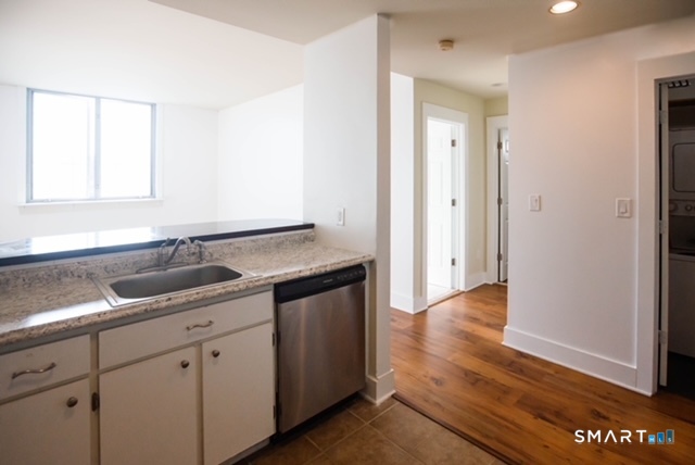 49 Day Street, Unit 404 Norwalk, CT 06854 - Photo 5 of 11 a view of a sink a mirror and cabinets