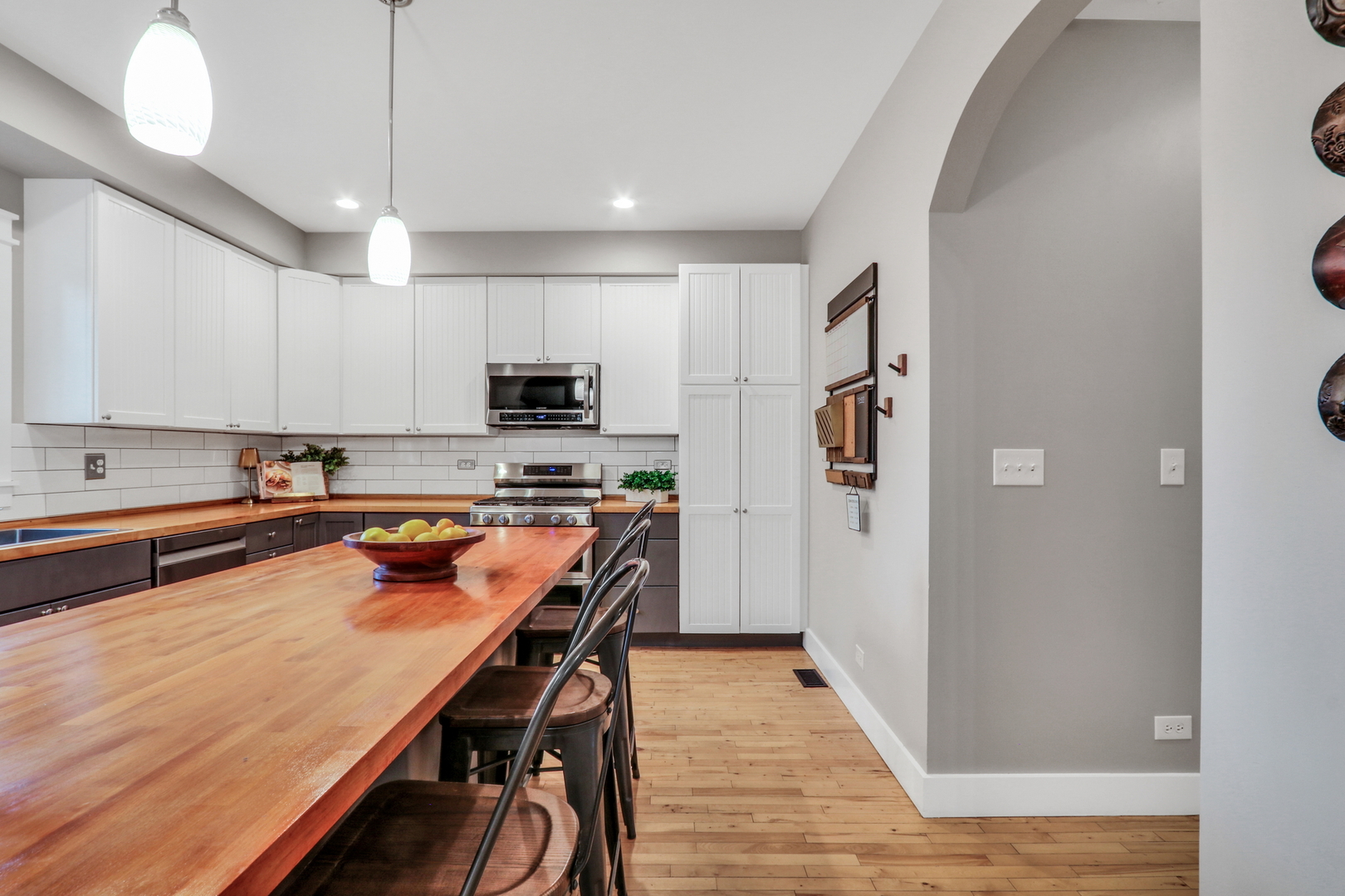 350 South Alleghany Road Grayslake, IL 60030 - Photo 11 of 54 a kitchen with stainless steel appliances a refrigerator a stove a sink dishwasher and white cabinets with wooden floor