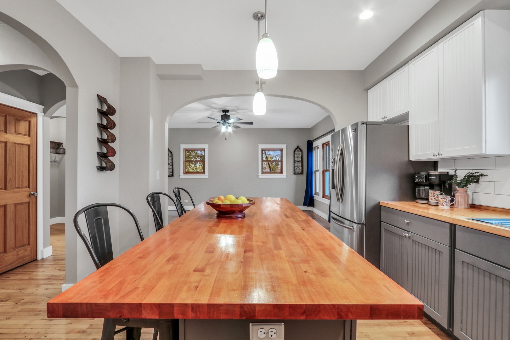 350 South Alleghany Road Grayslake, IL 60030 - Photo 12 of 54 a kitchen with stainless steel appliances kitchen island a table chairs in it and wooden floors