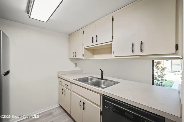 a kitchen with a sink and cabinets