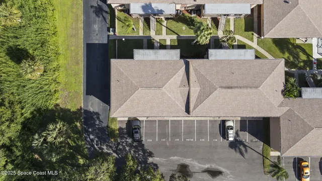an aerial view of a house with a yard