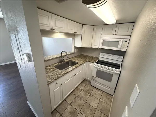 a kitchen with a stove and a refrigerator