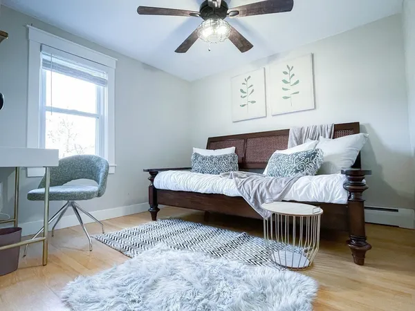 a bedroom with a bed and wooden floor