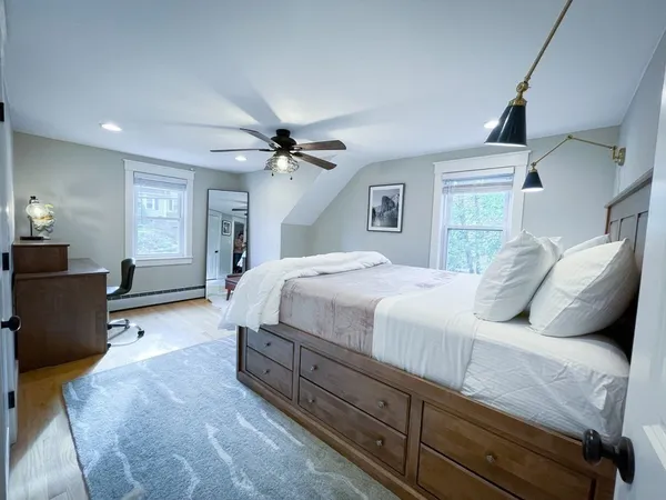 a bedroom with a large bed and a chandelier