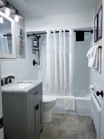 a bathroom with a sink toilet and shower